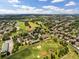 An aerial view of a golf course community with beautiful landscaping and well-maintained greens at 9319 Marsh Oaks Ct, Orlando, FL 32832