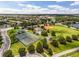 An aerial view shows a community park with tennis courts, playground, baseball field, pool, and walking trail at 9319 Marsh Oaks Ct, Orlando, FL 32832