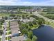 Neighborhood aerial view of tree lined streets near a lake and highway at 9319 Marsh Oaks Ct, Orlando, FL 32832