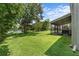 Lush backyard with a screened lanai and view of the pond, perfect for relaxation at 9319 Marsh Oaks Ct, Orlando, FL 32832