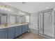 Bright bathroom boasts double sink vanity with gold fixtures, large mirror, soaking tub and walk-in shower at 9319 Marsh Oaks Ct, Orlando, FL 32832