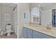 Bright bathroom with a single sink vanity and shower-tub with a striped curtain at 9319 Marsh Oaks Ct, Orlando, FL 32832