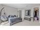 Bedroom with a suspended hammock chair, cozy sleeping nook, and ample closet space at 9319 Marsh Oaks Ct, Orlando, FL 32832