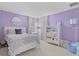 Purple bedroom filled with natural light featuring a bed and mirrored dresser at 9319 Marsh Oaks Ct, Orlando, FL 32832