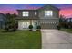 Charming two-story home with a well-manicured lawn, covered porch and a two car garage at 9319 Marsh Oaks Ct, Orlando, FL 32832