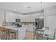 Modern kitchen featuring stainless steel appliances, white cabinets, quartz countertops, and a breakfast nook at 9319 Marsh Oaks Ct, Orlando, FL 32832