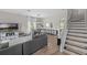 Bright living room with a modern staircase, an entertainment center, and a dining area at 9319 Marsh Oaks Ct, Orlando, FL 32832