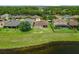 Aerial shot of the home, showing backyard, surrounding neighborhood, and pond, ideal for suburban living at 10151 Chorlton Cir, Orlando, FL 32832