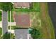 The aerial of the home shows nearby residences, with a grassy backyard running up to a lake at 10151 Chorlton Cir, Orlando, FL 32832