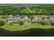 Aerial view showcases the homes nestled along a serene lake, surrounded by lush greenery at 10151 Chorlton Cir, Orlando, FL 32832