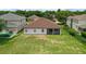 Aerial view of a large backyard with lawn and a screened-in patio, offering outdoor living space at 10151 Chorlton Cir, Orlando, FL 32832