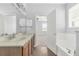 Charming bathroom features a double vanity with a view into the Primary bedroom at 10151 Chorlton Cir, Orlando, FL 32832