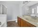 Bathroom with dual sinks, a large mirror, a soaking tub and glass enclosed shower at 10151 Chorlton Cir, Orlando, FL 32832