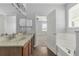 Bright bathroom with a soaking tub, dual sinks and granite countertops and access to the bedroom at 10151 Chorlton Cir, Orlando, FL 32832