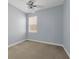 Bedroom features neutral carpet, light blue walls, and a window with blinds at 10151 Chorlton Cir, Orlando, FL 32832
