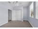 Bedroom with light blue walls, neutral carpet, window with blinds, and a double door closet at 10151 Chorlton Cir, Orlando, FL 32832