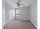 Spare bedroom with double door closet, neutral walls and flooring, and large window at 10151 Chorlton Cir, Orlando, FL 32832
