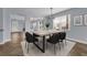 Inviting dining room with an elegant chandelier and large windows for natural light at 10151 Chorlton Cir, Orlando, FL 32832
