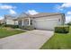 Charming single-story home with a well-manicured lawn, mature landscaping, and a two-car garage at 10151 Chorlton Cir, Orlando, FL 32832
