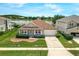 Aerial view of a single-story home with beautiful landscaping and a view of the lake at 10151 Chorlton Cir, Orlando, FL 32832