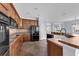 Open kitchen layout with ample counter space, wood cabinets, and modern black appliances at 10151 Chorlton Cir, Orlando, FL 32832