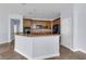 Traditional kitchen featuring wooden cabinetry, tiled floor, and a center island with bar seating at 10151 Chorlton Cir, Orlando, FL 32832