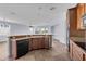 Open kitchen with bar and black appliances flowing into a living space with plenty of natural light at 10151 Chorlton Cir, Orlando, FL 32832
