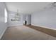 Bright and airy living area with tile flooring, large windows, and an open layout, seamlessly connecting to other rooms at 10151 Chorlton Cir, Orlando, FL 32832