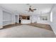 Bright and airy living room with a ceiling fan, seamlessly connecting to the kitchen and dining area in an open concept layout at 10151 Chorlton Cir, Orlando, FL 32832