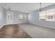 Spacious living room with a light gray carpet, decorative chandelier, and plenty of natural light at 10151 Chorlton Cir, Orlando, FL 32832