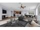 Open-concept living room with a ceiling fan, adjacent to the kitchen, and dining area, creating an inviting space at 10151 Chorlton Cir, Orlando, FL 32832