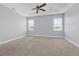 Large main bedroom featuring a ceiling fan, neutral carpet, and window at 10151 Chorlton Cir, Orlando, FL 32832