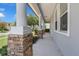 Inviting covered front porch featuring substantial stone support columns and a smooth concrete floor at 10151 Chorlton Cir, Orlando, FL 32832