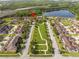 Aerial view of community featuring lush green spaces and sidewalks between residences at 11081 Savannah Landing Cir, Orlando, FL 32832