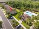 Aerial view of townhomes with a pool, clubhouse, and palm tree landscaping at 11081 Savannah Landing Cir, Orlando, FL 32832