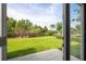 A view of the landscaped backyard including a lawn, trees, community features and a paver patio at 11081 Savannah Landing Cir, Orlando, FL 32832