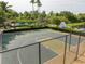 Community basketball court surrounded by lush greenery, and a community pool at 11081 Savannah Landing Cir, Orlando, FL 32832