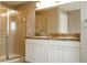 Bathroom featuring a glass-enclosed shower and a double sink vanity with cabinet storage at 11081 Savannah Landing Cir, Orlando, FL 32832