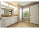 Bright bathroom features double sinks, granite countertops, and a window for natural light at 11081 Savannah Landing Cir, Orlando, FL 32832