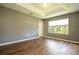 Bedroom with tray ceiling and natural light from the window at 11081 Savannah Landing Cir, Orlando, FL 32832