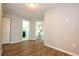 An interior of a room with wood-look vinyl flooring, and views into the bathroom and kitchen at 11081 Savannah Landing Cir, Orlando, FL 32832