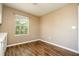 Bright bedroom featuring wood-look floors and a window providing natural light at 11081 Savannah Landing Cir, Orlando, FL 32832