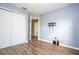 Bedroom features hardwood floor, closet with sliding doors, wall mounted TV and a door to the bathroom at 11081 Savannah Landing Cir, Orlando, FL 32832