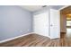 Bedroom featuring hard wood floor, closet with sliding doors, a window, and a white door at 11081 Savannah Landing Cir, Orlando, FL 32832
