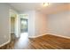 Bedroom with wood-look vinyl flooring and neutral walls; views into the bathroom and closet at 11081 Savannah Landing Cir, Orlando, FL 32832