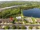 Aerial view of townhomes with a pool, lake, and tennis court at 11081 Savannah Landing Cir, Orlando, FL 32832