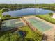 Aerial view of a basketball and tennis court, playground, and lake at 11081 Savannah Landing Cir, Orlando, FL 32832