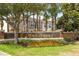 Community entrance sign for Mona Terrace, enhanced by colorful flowers at 11081 Savannah Landing Cir, Orlando, FL 32832