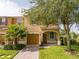 Charming two-story townhome featuring a one car garage, well maintained lawn, and mature trees at 11081 Savannah Landing Cir, Orlando, FL 32832