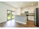 Modern kitchen with stainless steel appliances, granite countertops, and an island with seating at 11081 Savannah Landing Cir, Orlando, FL 32832